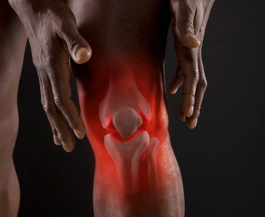 Joints of mixed race man's knee --- Image by © John Lund/Blend Images/Corbis