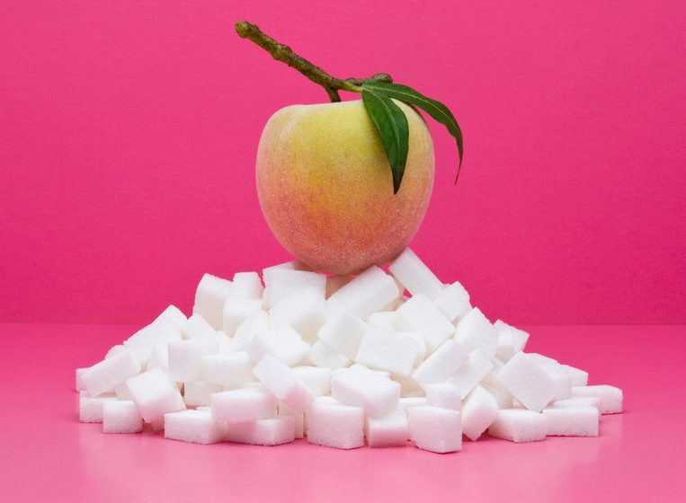 Food concept, fresh peach on top of pile of sugarcubes --- Image by © Milena Boniek/PhotoAlto/Corbis
