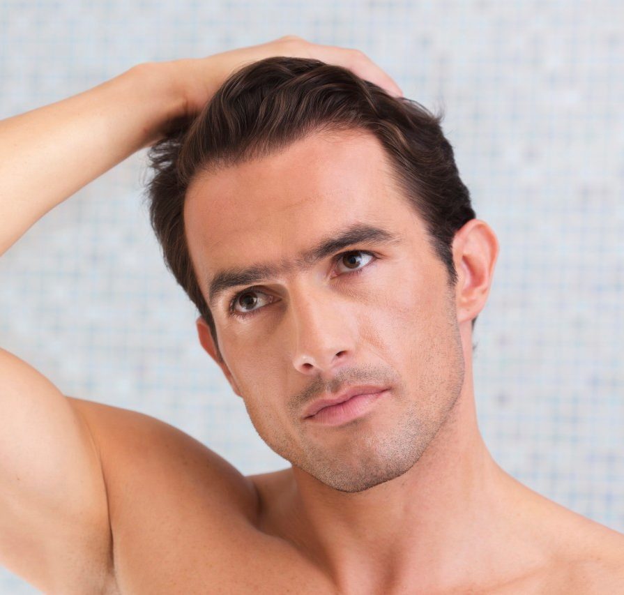 26 Aug 2013 --- Portrait of man with hand in his hair --- Image by © Milton Brown/Westend61/Corbis