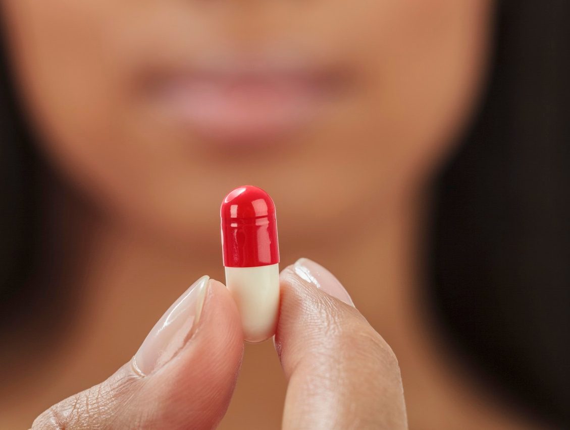 24 Sep 2012 --- Close up of mixed race woman holding medication capsule --- Image by © GP Kidd/Blend Images/Corbis