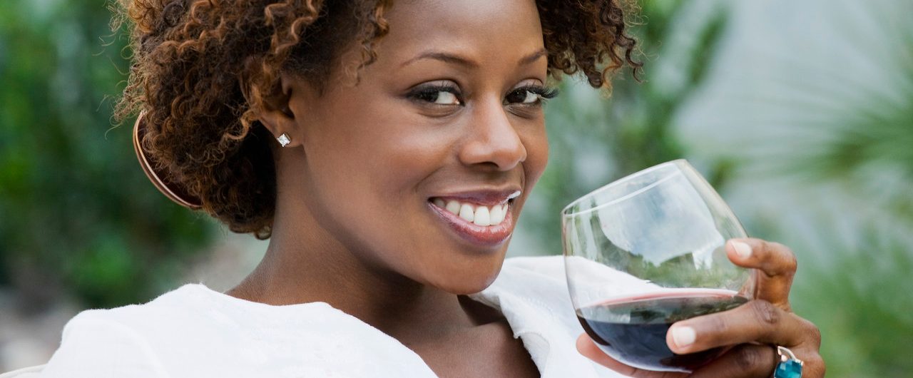 African American woman drinking red wine --- Image by © Inti St. Clair/Blend Images/Corbis