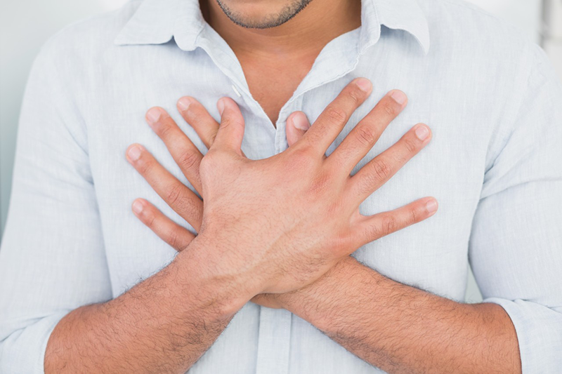01 Aug 2013 --- Mid section of man with chest pain --- Image by © Wavebreak Media LTD/LightWave/Corbis