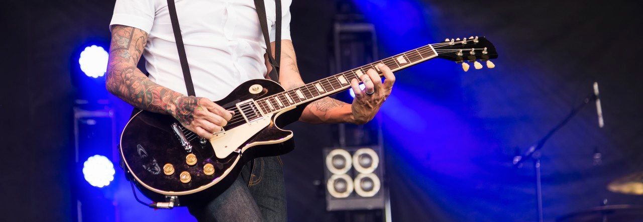 Edmonton, Alberta, Canada --- Young musician playing guitar at a concert; Edmonton, Alberta, Canada --- Image by © LJM Photo/Design Pics/Corbis
