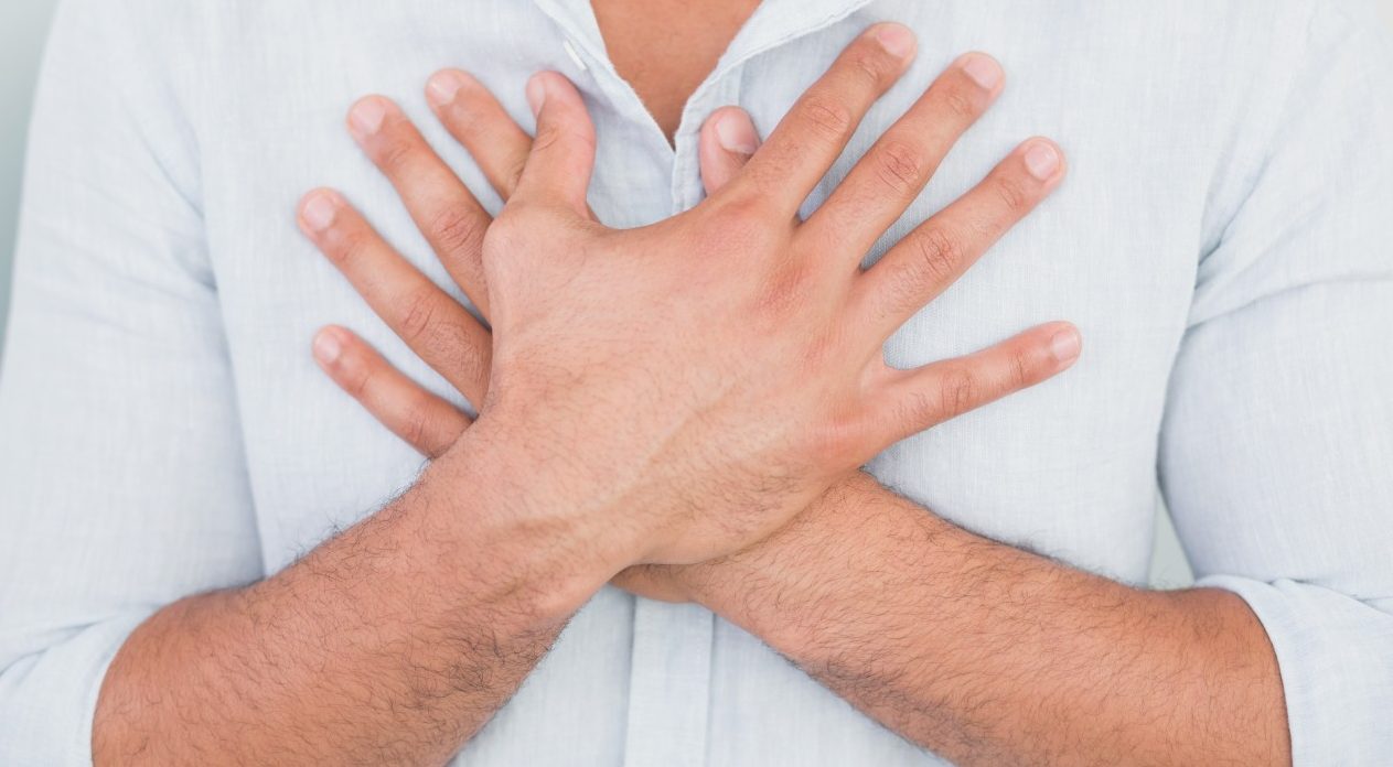 01 Aug 2013 --- Mid section of man with chest pain --- Image by © Wavebreak Media LTD/LightWave/Corbis