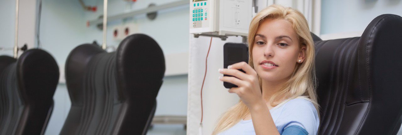 Mallorca, Spain --- Blonde woman relaxing in a chair while getting dialysis --- Image by Â© Wavebreak Media Ltd./Corbis