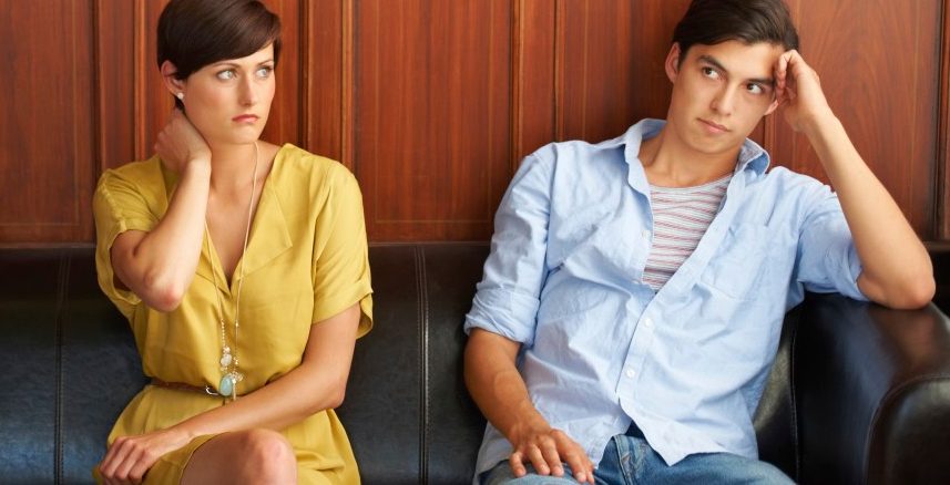 Portrait of three bored-looking young people sitting on a sofa --- Image by © 13/PeopleImages.com/Ocean/Corbis
