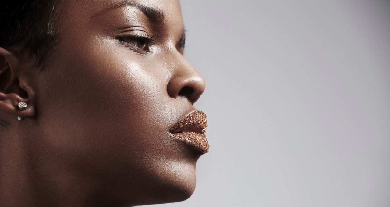 Close-up of woman face with make-up and earring --- Image by © pinkypills/Corbis