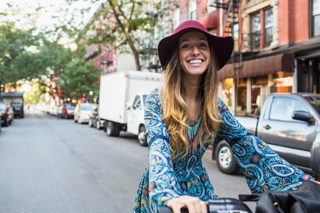 Portrait of young woman on bicycle --- Image by © Boone Rodriguez/Corbis