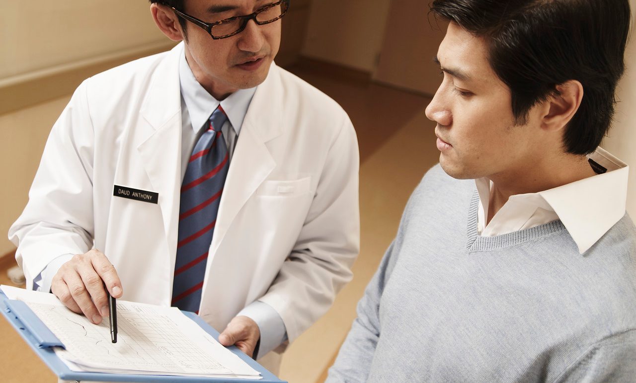 Doctor Talking with Patient --- Image by © Milk Photographie/Corbis
