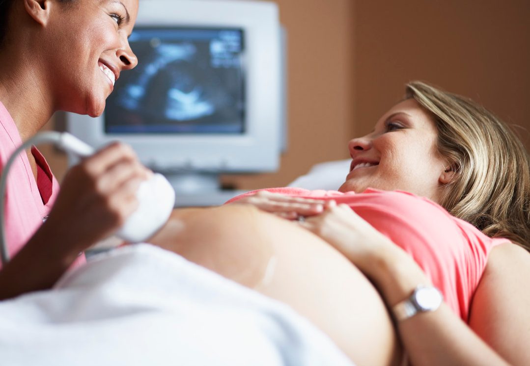 Nurse Conducting Ultrasound Examination --- Image by © Sean Justice/Corbis
