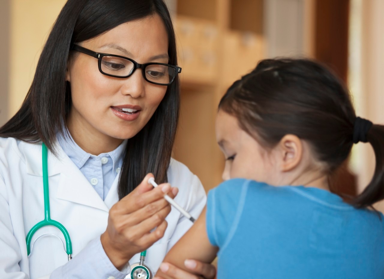 31 Aug 2010 --- Doctor giving young girl injection in arm --- Image by © Ariel Skelley/Blend Images/Corbis