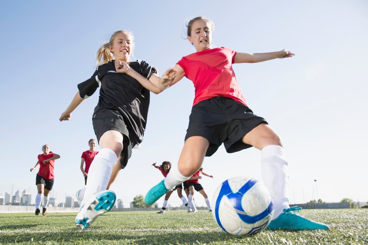 21 Sep 2012 --- Soccer girls racing for soccer ball. --- Image by © Hero Images/Corbis