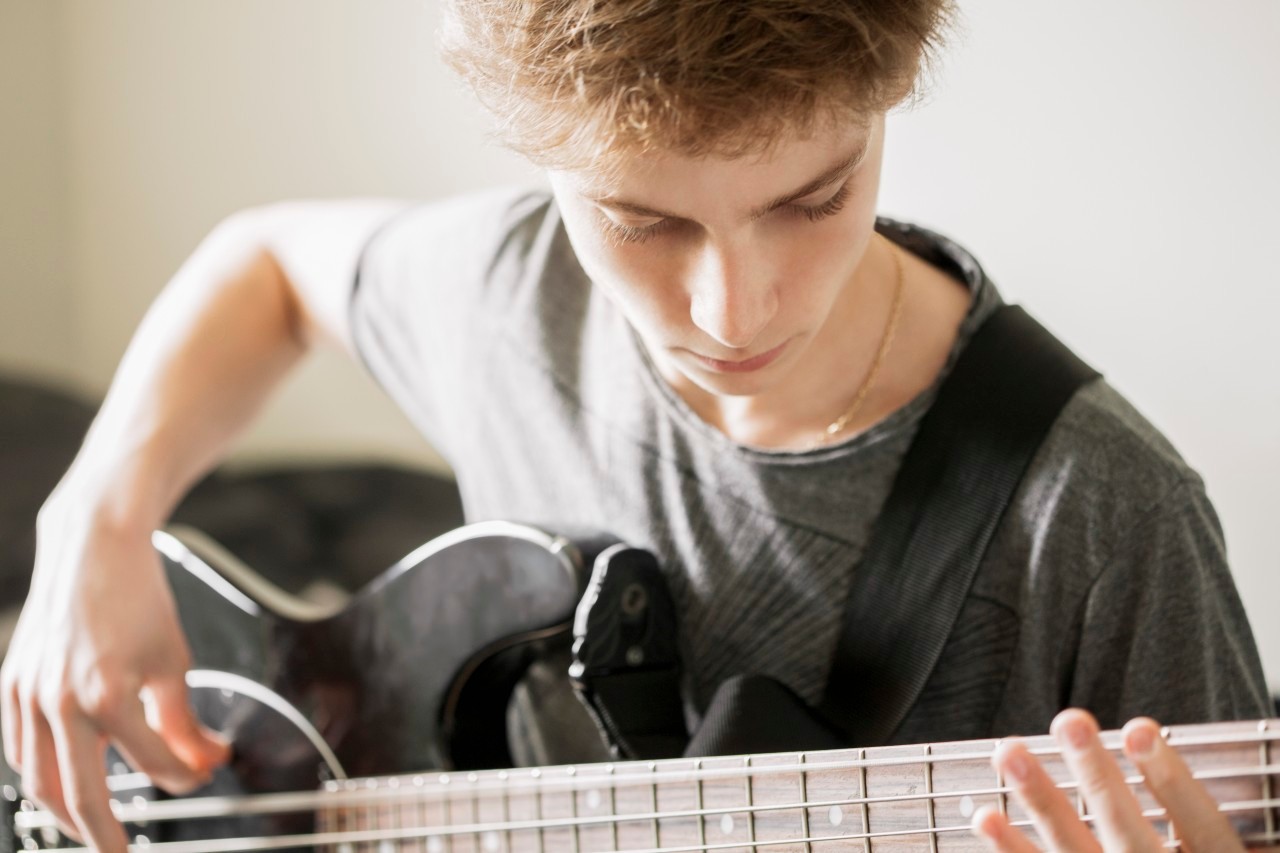 28 Oct 2013 --- Teenage boy playing a guitar --- Image by © Letizia Le Fur/Onoky/Corbis