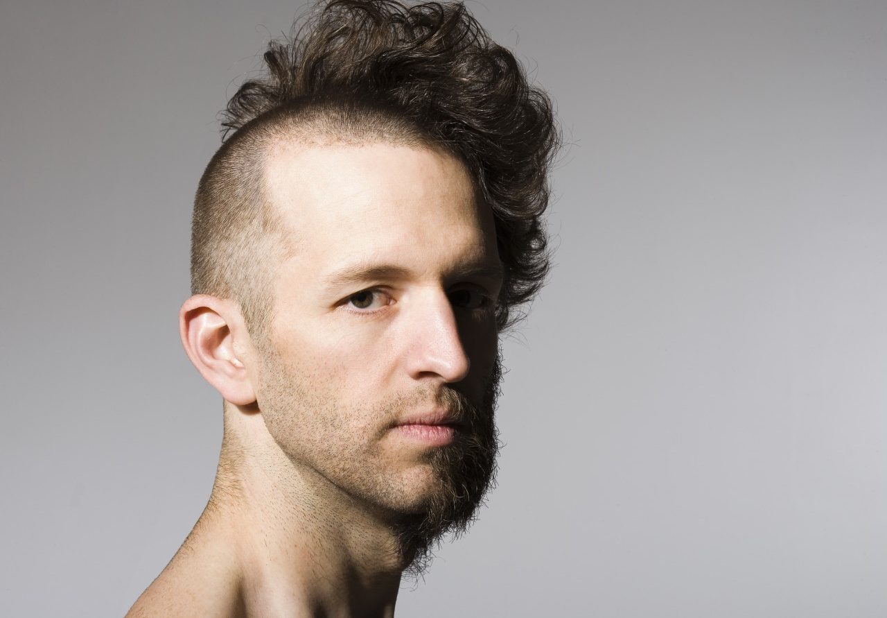 14 Nov 2006 --- Shirtless man with half shaved hair and beard --- Image by © Mike Kemp/Rubberball/Corbis