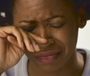 Close-up of African American woman with  her hand to her face crying. Source:84281_1,  PWS_BXP28948h,4.1.1