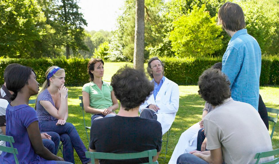 Circle of people in rehab, outdoors --- Image by © Ghislain & Marie David de Lossy/cultura/Corbis