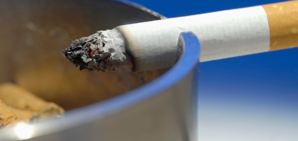 Cigarette on ashtray, close up --- Image by © Claudia Rehm/Westend61/Corbis