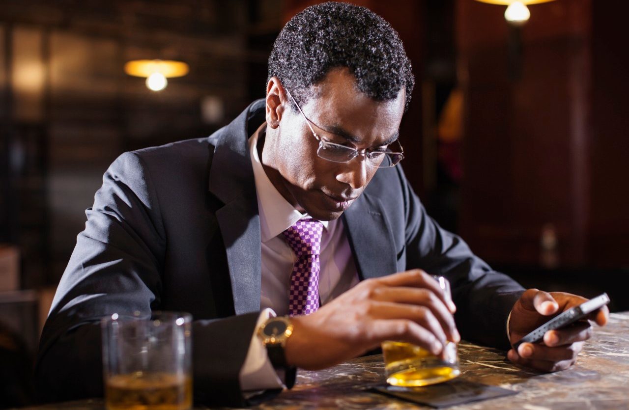 Businessman sitting at bar counter --- Image by © Sonja Pacho/Corbis