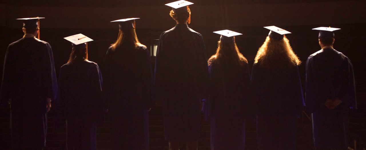 Clover, South Carolina, USA --- Students Standing on Stage at High School Graduation Ceremony --- Image by © 68/Ocean/Corbis