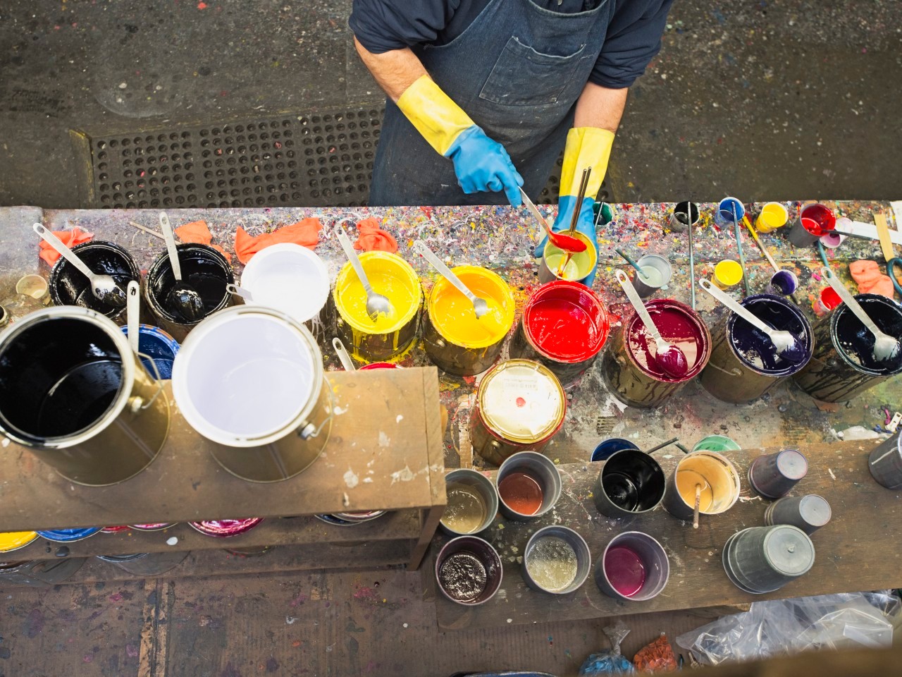 22 Feb 2013 --- Hispanic worker mixing paint in workshop --- Image by © Erik Isakson/Blend Images/Corbis