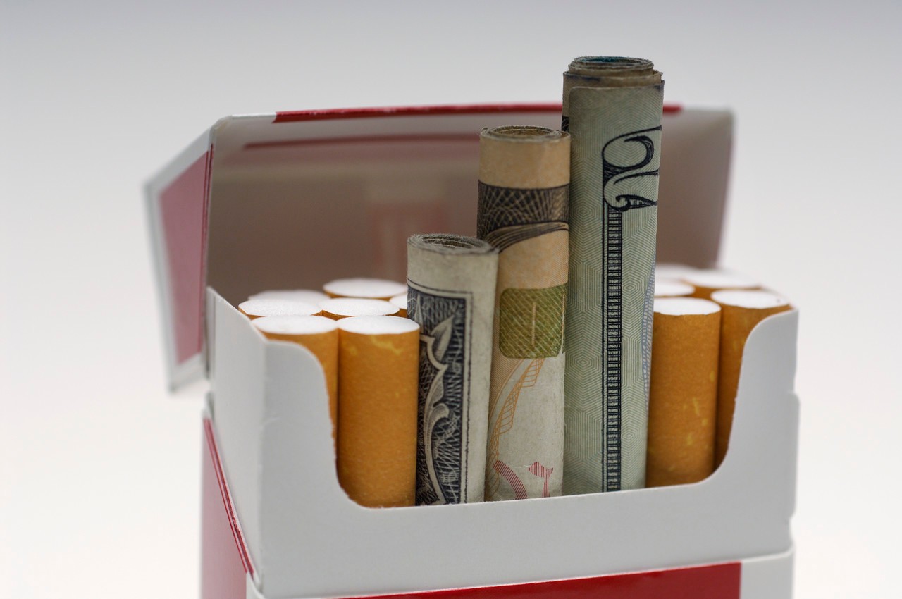 Cigarettes and Money --- Image by © moodboard/Corbis
