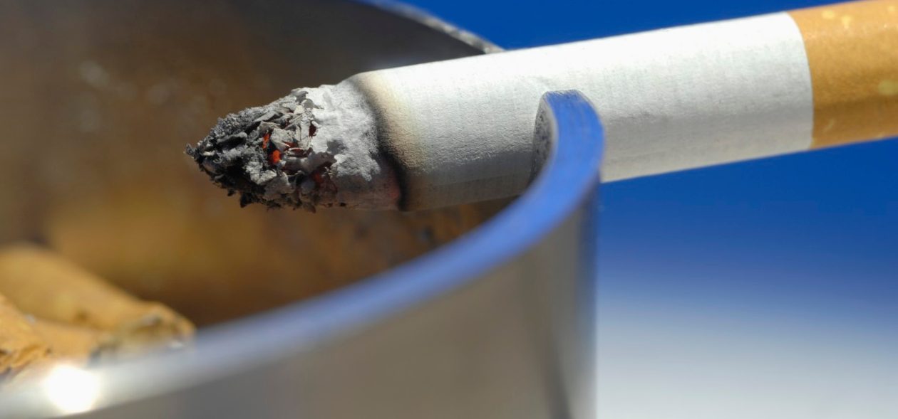 Cigarette on ashtray, close up --- Image by © Claudia Rehm/Westend61/Corbis
