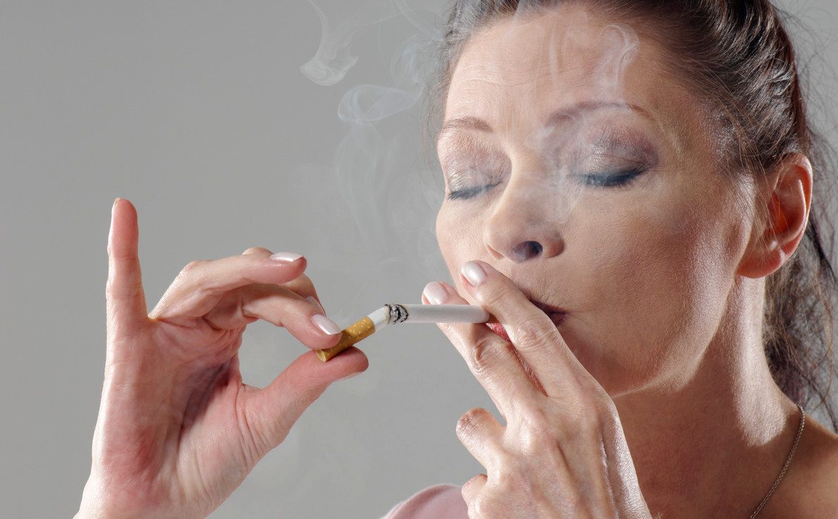Woman Chain Smoking --- Image by © Wolf/Corbis