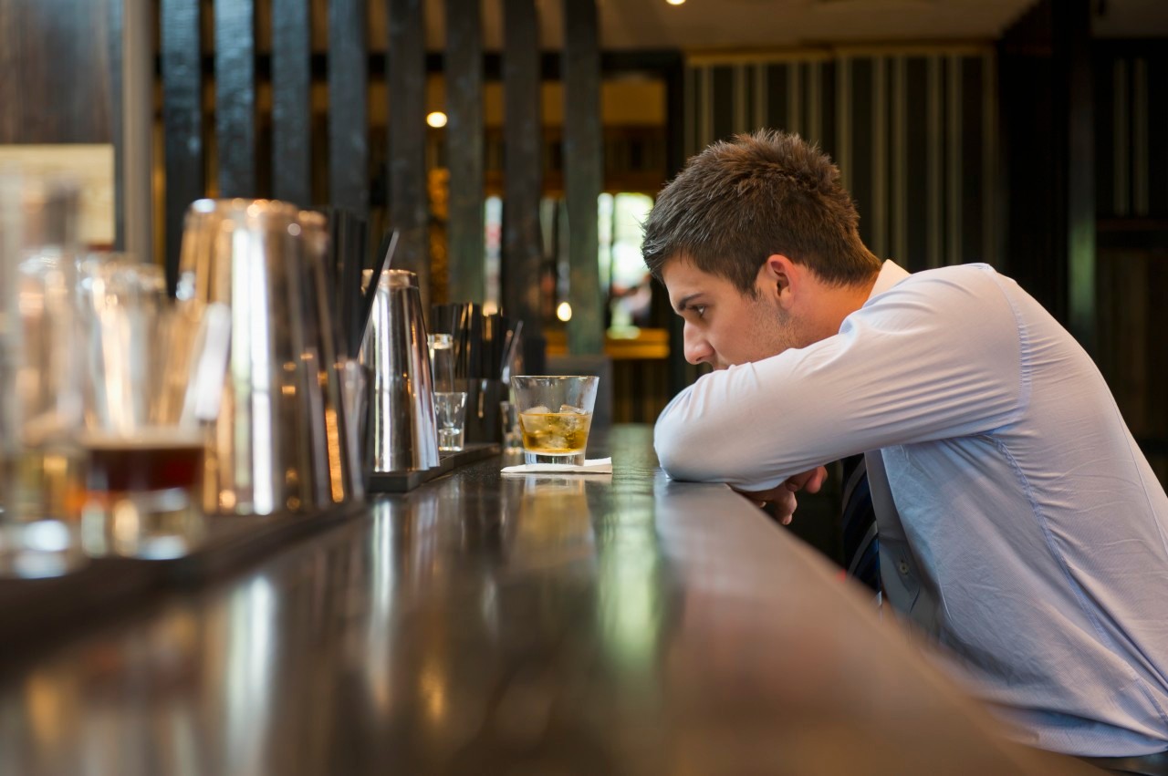 Dejected businessman having drink at bar --- Image by © Les and Dave Jacobs/cultura/Corbis