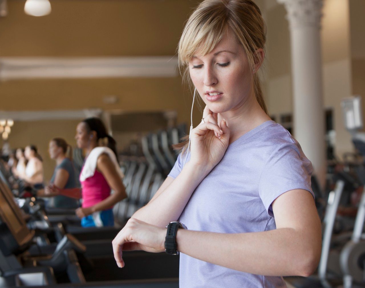 11 May 2012 --- Caucasian woman checking pulse in gym --- Image by © Jose Luis Pelaez Inc/Blend Images/Corbis