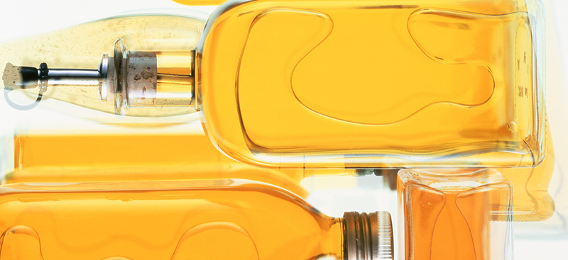 Bottles of cooking oil --- Image by © Christian Schmidt/Corbis