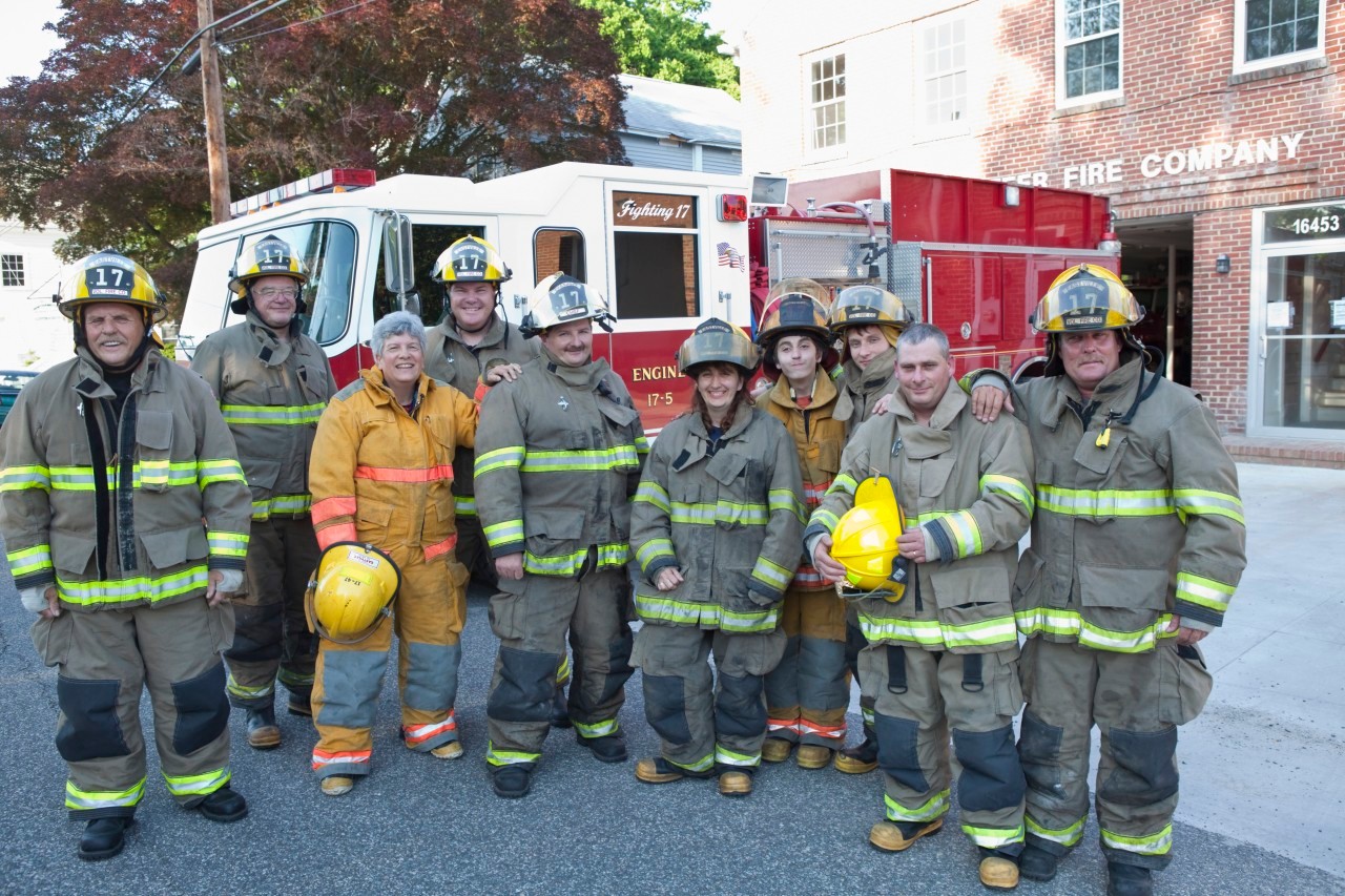 25 May 2011 --- Volunteer firefighters posing outside fire house --- Image by © Ariel Skelley/Blend Images/Corbis