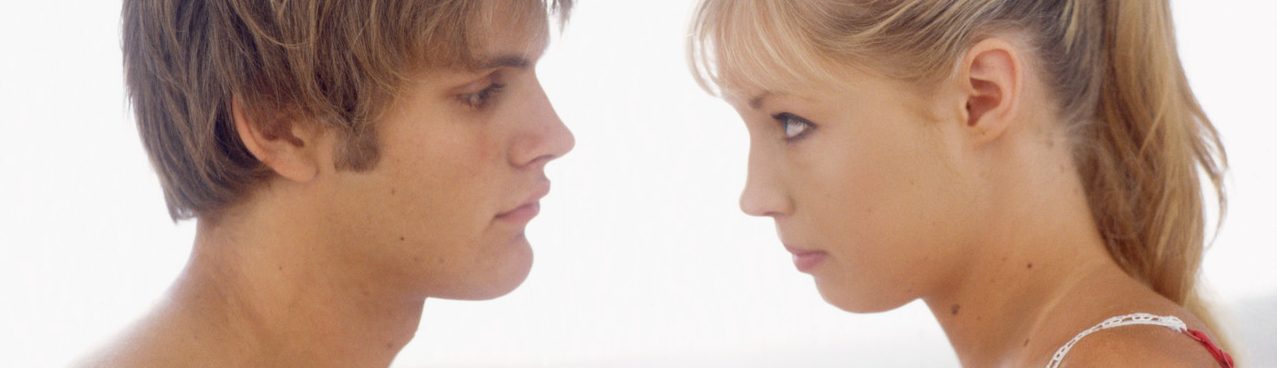 Young Couple in Bedroom, Woman Holding Condom --- Image by © Michael A. Keller/Corbis